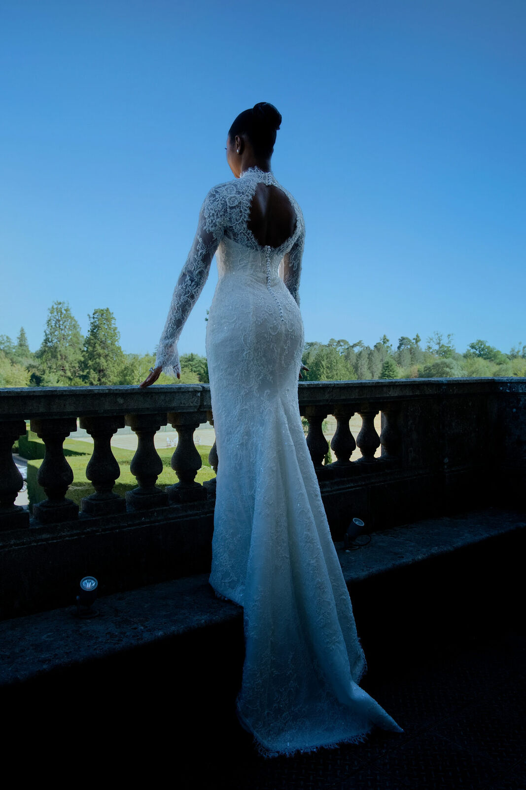 A bride on a stone balcony at dusk, Hedsor House